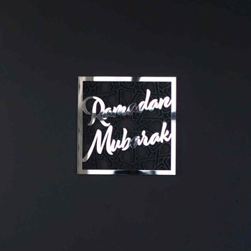 Silver Ramadan Mubarak square wall art with geometric pattern on a dark charcoal wall