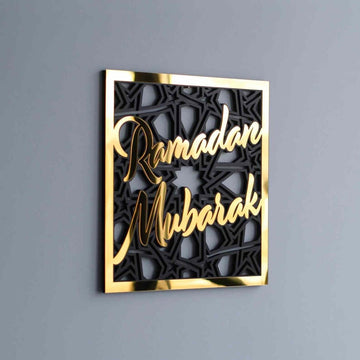 Gold Ramadan Mubarak square wall art with black geometric star pattern, large view on a gray wall